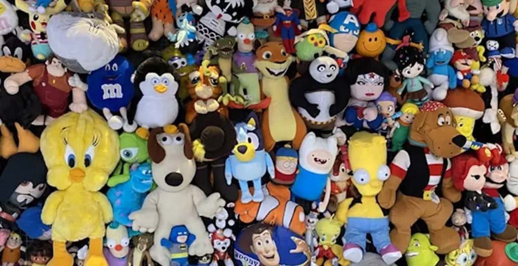 Large assortment of colorful plush toys featuring popular cartoon and movie characters displayed together.