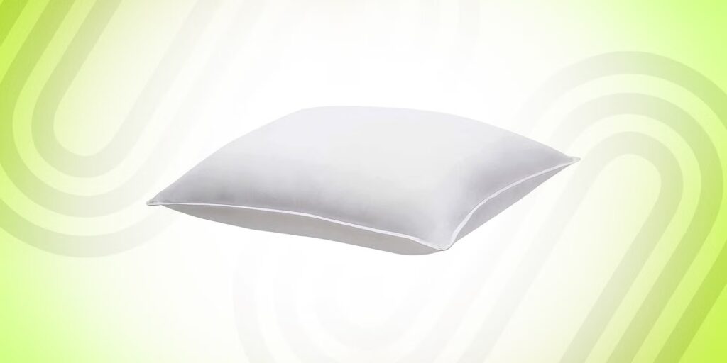 White bed pillow with smooth fabric cover displayed against a bright green and white gradient background.