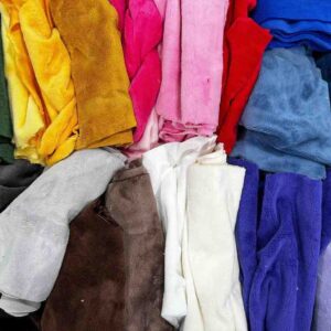 Assorted colorful plush fabrics in various textures arranged in a pile.
