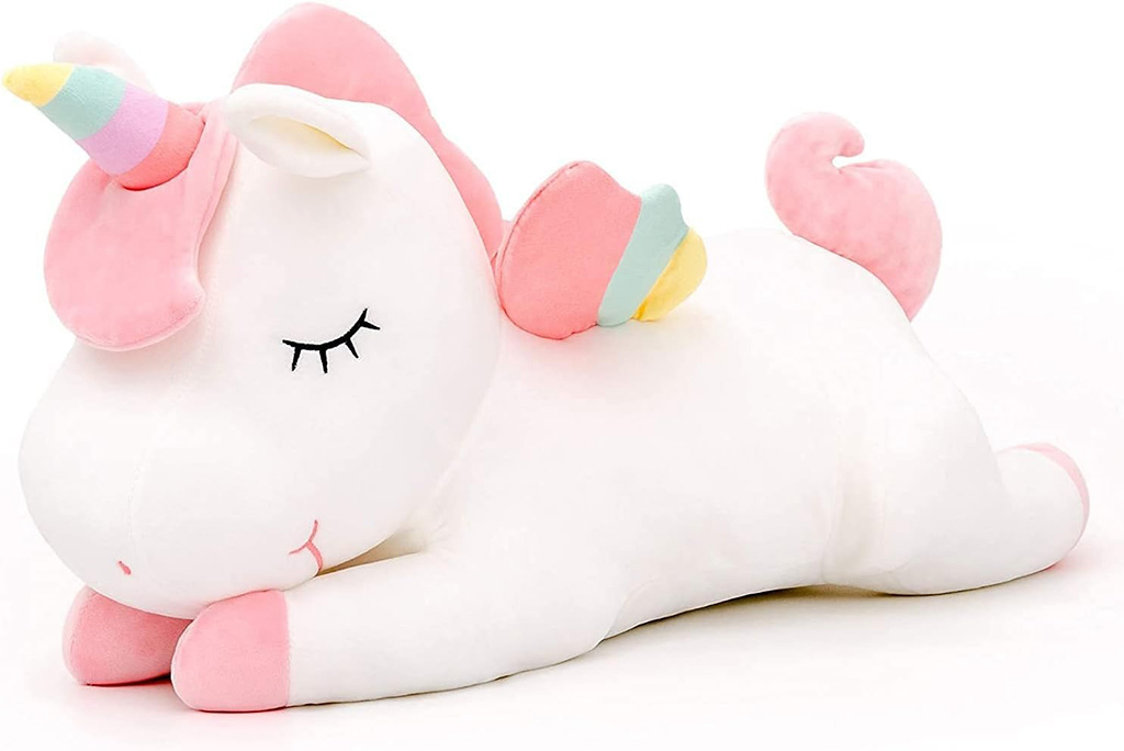 A soft white unicorn plush toy with pink ears, hooves, and mane, a pastel rainbow horn, and colorful wings, shown lying down with closed embroidered eyes in a cute sleeping pose.