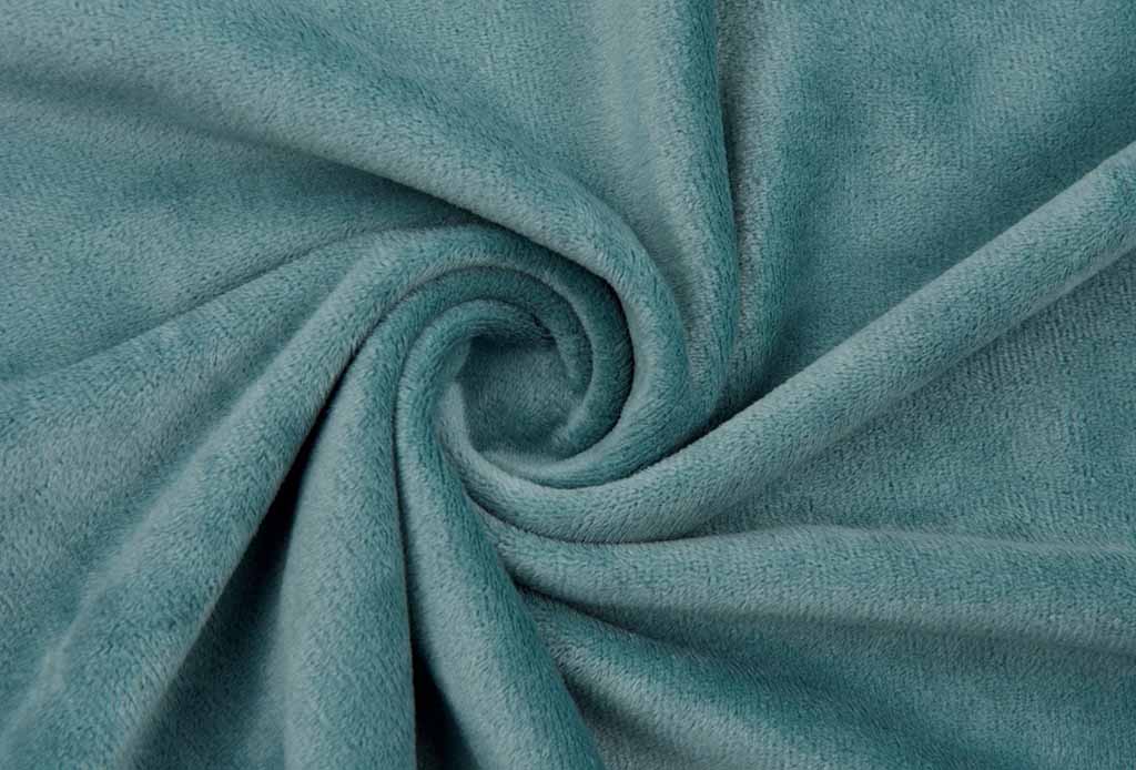 Close-up of teal smooth minky fabric twisted into a spiral, showing its soft texture and velvety surface ideal for plush toys.