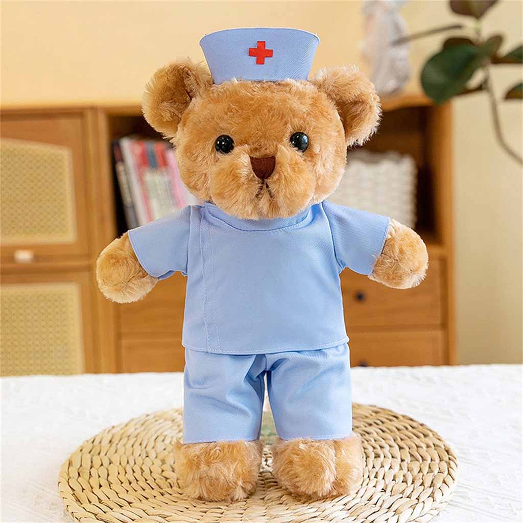 Cute brown teddy bear plush dressed in a blue nurse outfit with a matching hat and red cross, standing on a woven mat indoors.