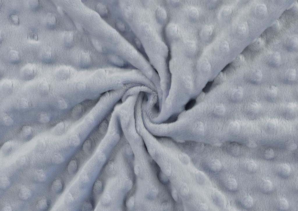  Close-up of soft blue minky dot fabric showing its plush surface and raised dotted texture, ideal for baby toys and stuffed animals.