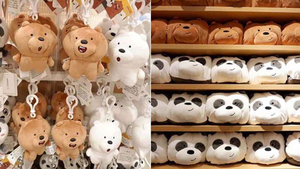 : Shelves and hanging racks filled with brown, white, and panda bear plush toys and keychains displayed in a store, organized neatly by character.