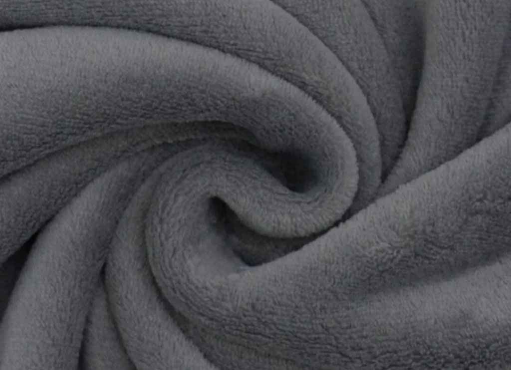 Close-up of dark gray fleece fabric showing its smooth, warm, and plush texture, commonly used for plush toys and cozy blankets.