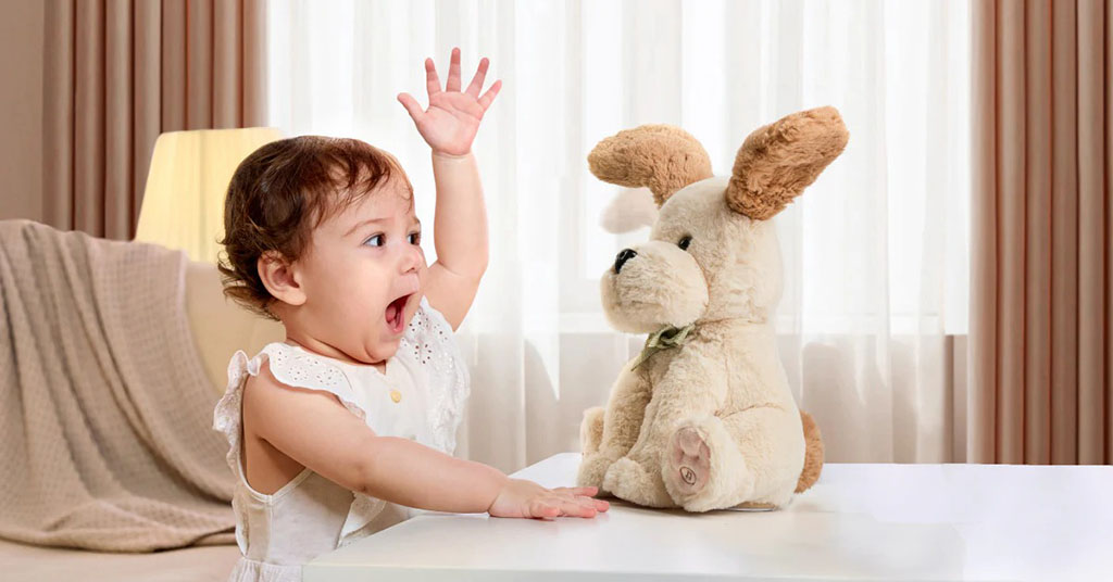 Baby reaching up excitedly toward a soft plush dog toy on a table, showing curiosity, interaction, and early sensory play.