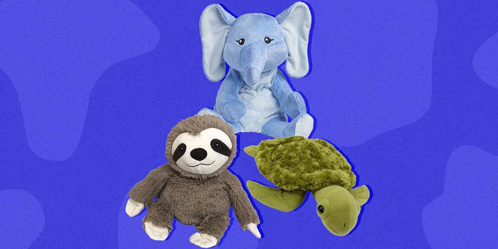 Three soft weighted plush animals on a blue background, including a light blue elephant sitting upright, a smiling gray sloth with white face details, and a green turtle lying flat with textured shell.