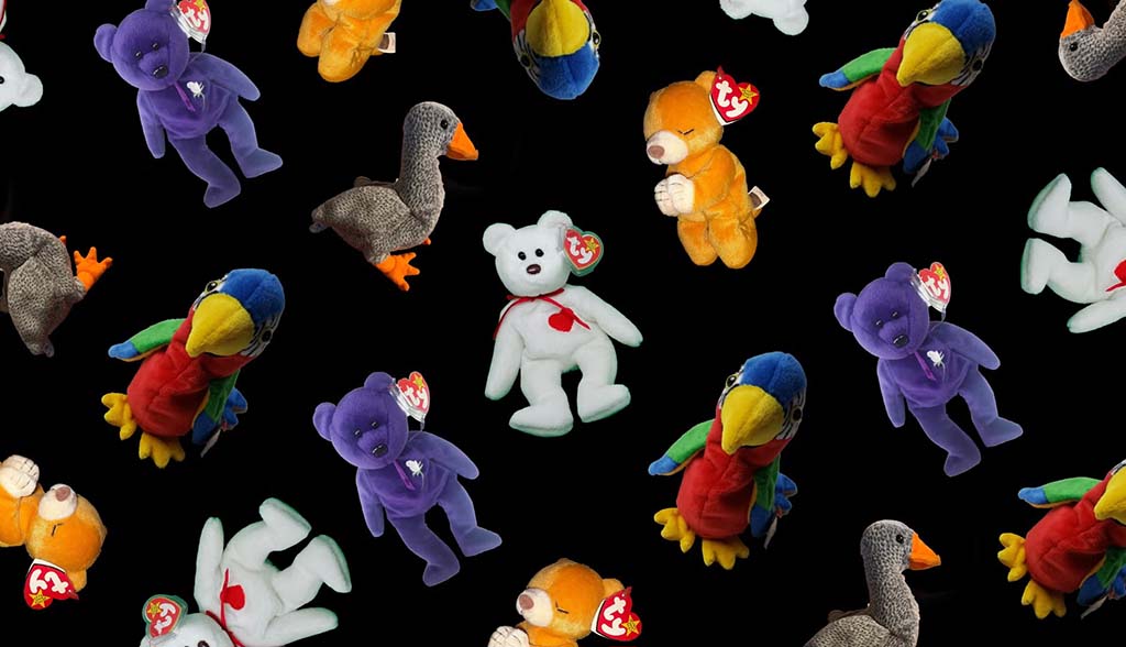 Assorted Ty Beanie Babies plush toys scattered on a black background, including teddy bears, parrots, ducks, and other colorful stuffed animals with heart-shaped Ty tags.