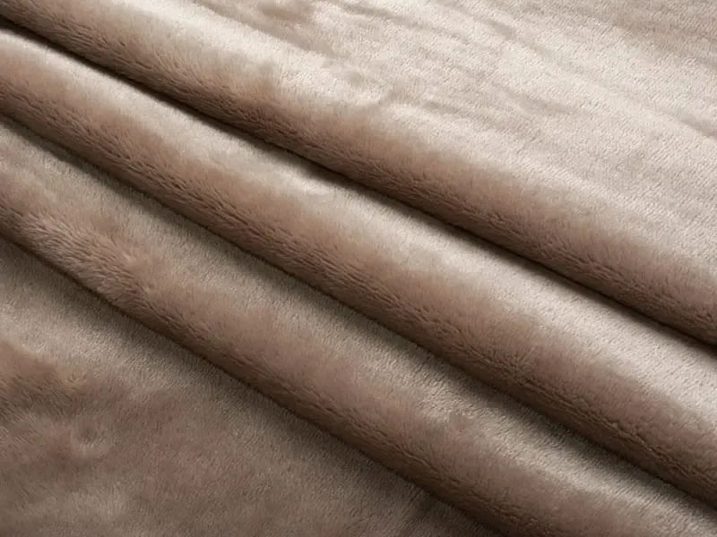 Close-up view of plush fabric with smooth, short pile texture and soft surface, commonly used for high-quality stuffed animals and plush toys.