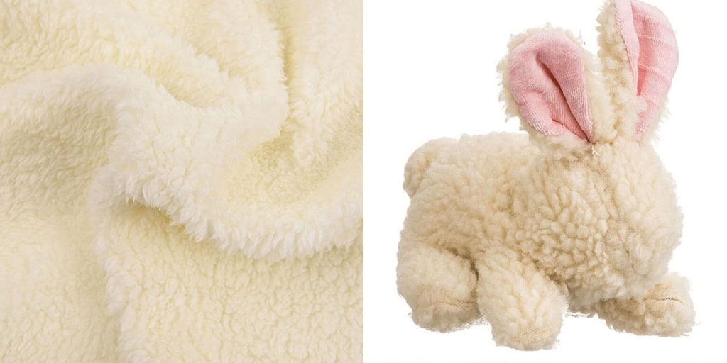 Sherpa fleece fabric close-up with thick, fluffy pile alongside a plush bunny toy, showing the soft, wool-like texture commonly used for cozy stuffed animals.