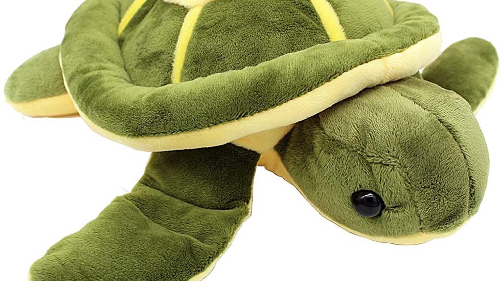 Green turtle plush toy with soft velour fabric, rounded shell, and floppy flippers, shown in a close-up side view.
