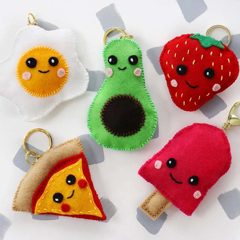 Cute felt food plush keychains shaped like egg, avocado, strawberry, pizza, and popsicle.