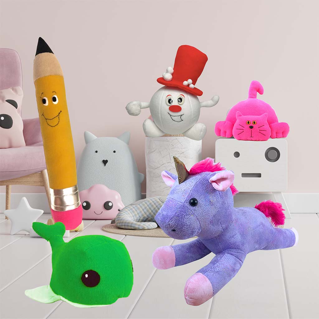 A group of colorful plush toys including a green whale, purple unicorn, tall pencil plush, snowman plush, and pink cat arranged in a pastel children’s room setting with cute decor elements.