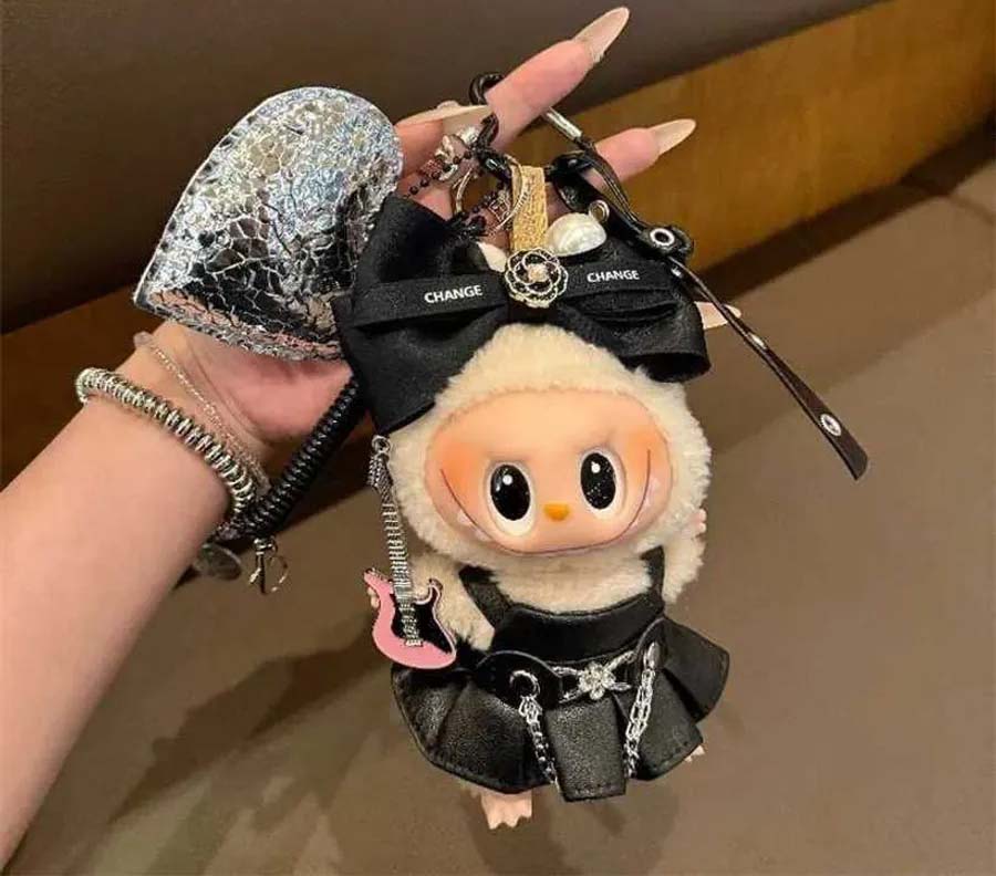 Cute designer plush keychain doll with black outfit and accessories.