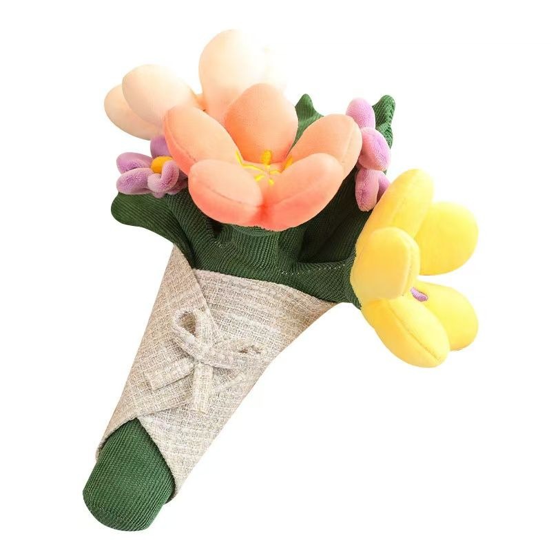 A soft plush flower bouquet with pink, yellow, and purple blooms wrapped in a fabric cone tied with a bow.