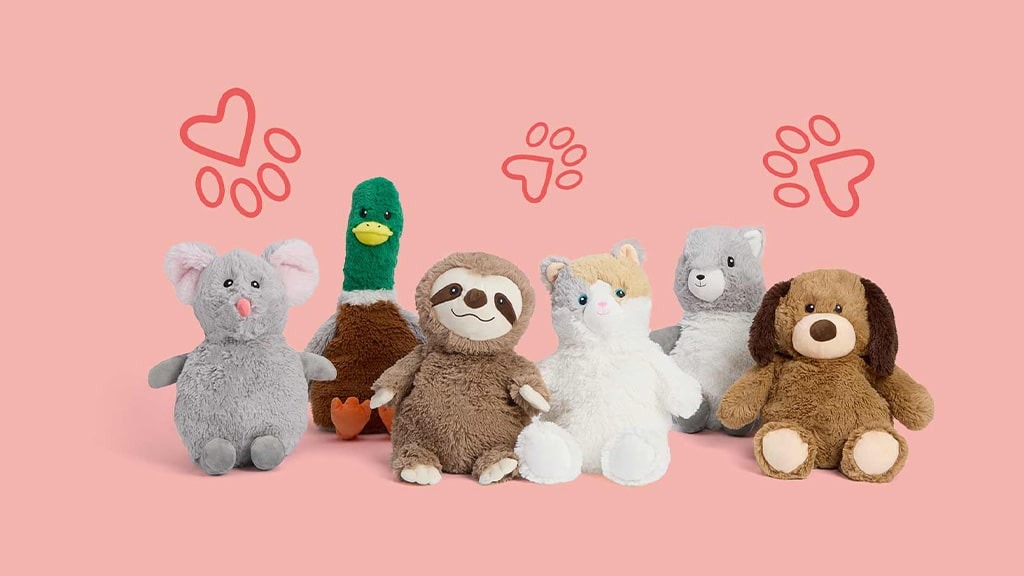 Six plush animal toys lined up against a pink background, including a gray mouse, green duck, brown sloth, white cat, gray bear, and brown dog, with playful heart and paw illustrations above them.