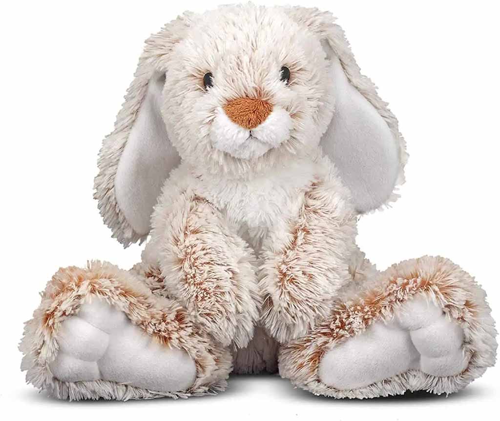 Soft white bunny stuffed animal with long floppy ears, plush fur texture, and oversized padded feet sitting upright.