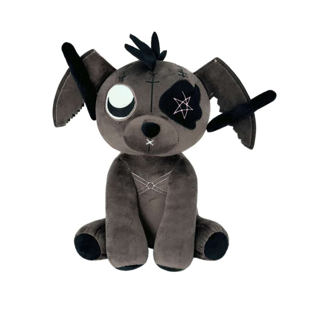 A grey punk-style bunny plush toy with stitched details, one white eye and one black patch with a pink pentagram, floppy ears decorated with black fabric strips, and cross-stitch embroidery on the body, sitting upright on a white background.