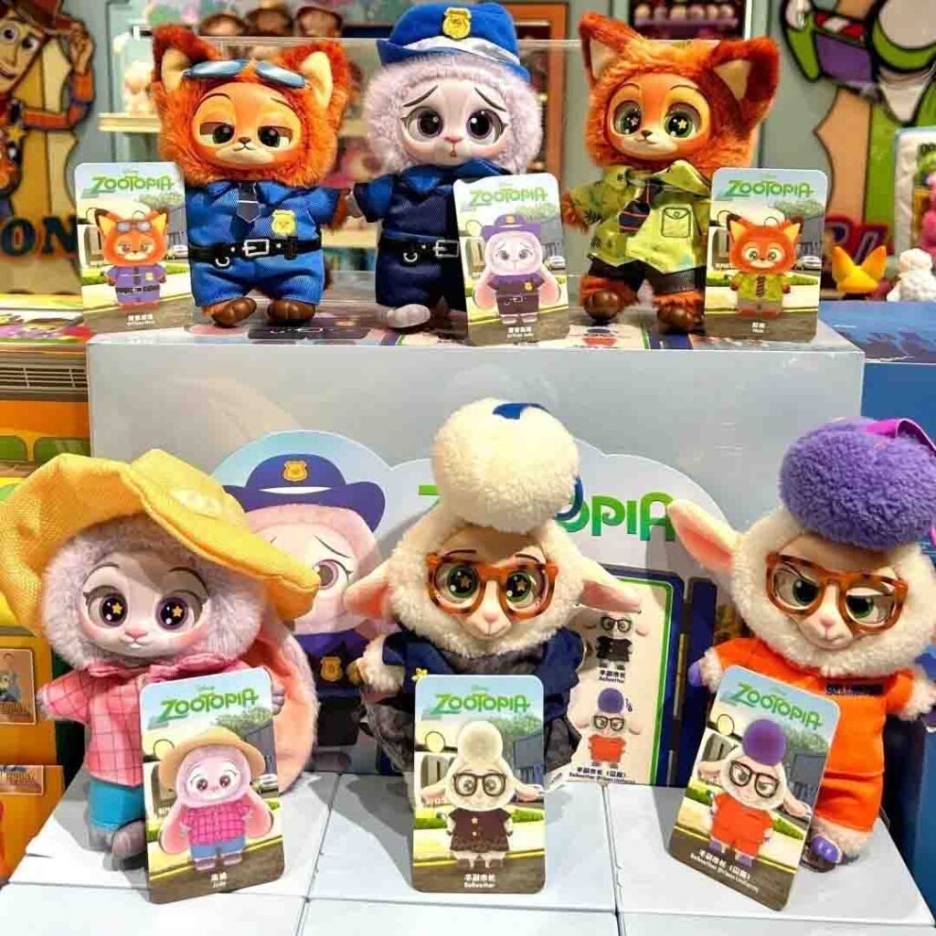 Cute Zootopia-inspired plush dolls displayed in two rows, featuring characters dressed as police officers, a fox in a green shirt, and sheep characters with hats and glasses, each shown with matching character cards.