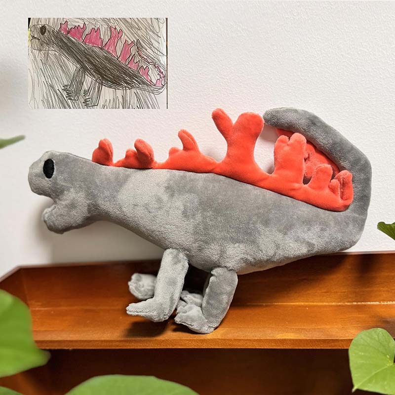 Handmade dinosaur plush toy created from a child’s drawing, showing the finished custom stuffed animal alongside the original kids artwork for personalized plush manufacturing.