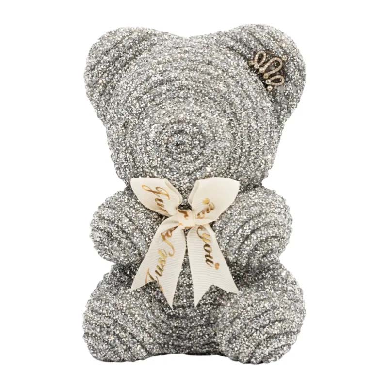 Silver glitter teddy bear ornament with spiral textured surface and cream ribbon bow, designed as a decorative gift piece.
