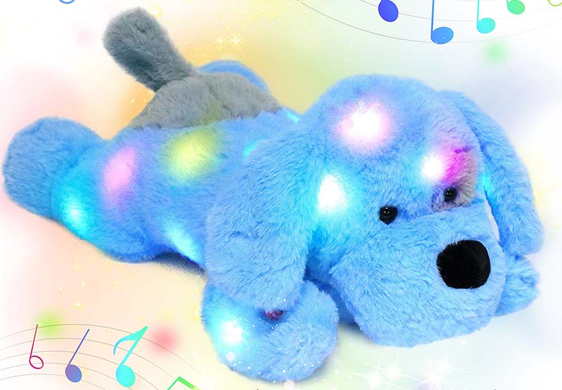 Light-up musical plush dog toy glowing with colorful LED lights
