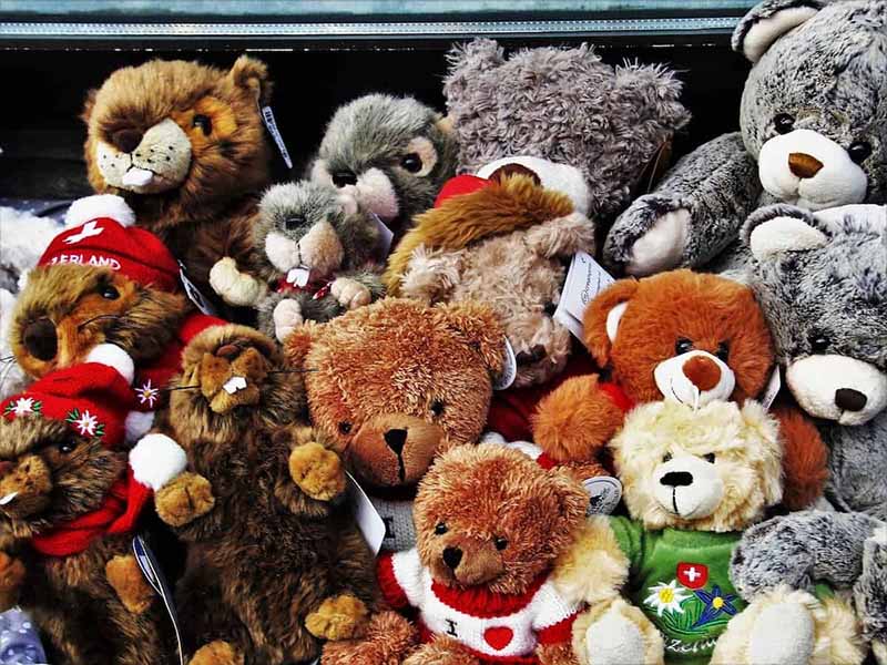 Assorted teddy bears wearing winter and holiday outfits