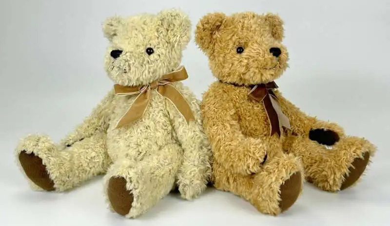 Two classic teddy bears sitting side by side