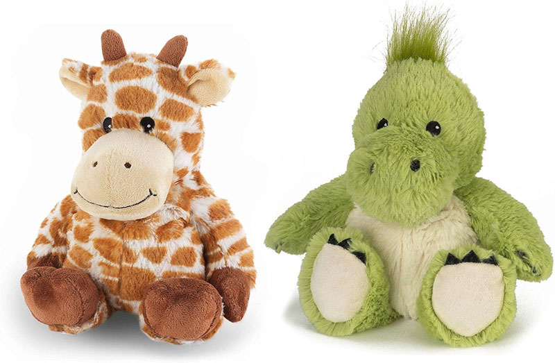 Two plush stuffed animals on a white background, featuring a smiling giraffe and a green dinosaur sitting side by side