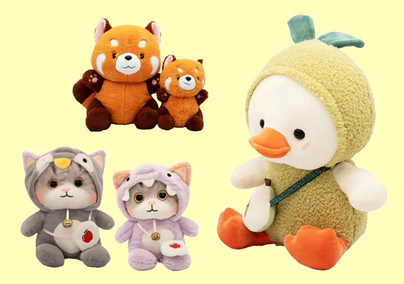Assorted cute plush toys on a light background, including two red panda dolls, two kitten plushies in costumes, and a duck plush wearing a green hood.
