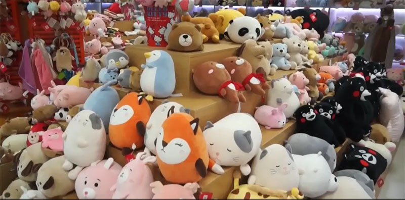 A large selection of finished plush toys showcasing different characters, sizes, colors, and styles, demonstrating strong design diversity and mass-production capability.