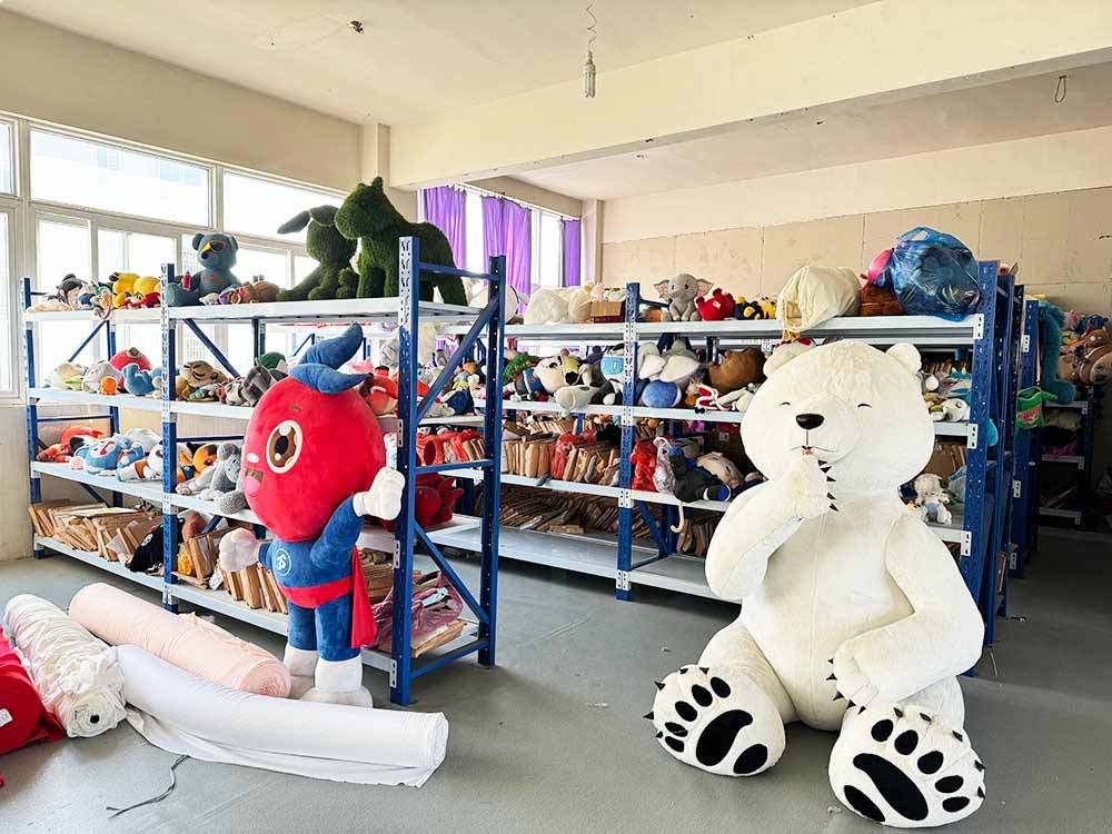 Plush toys arranged on industrial shelves in a workshop space, showcasing sample development and inventory organization.