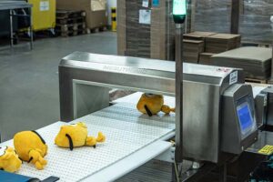 Plush toys undergoing metal detection during production to ensure product safety and quality compliance.
