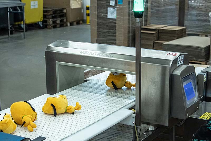Plush toys undergoing metal detection during production to ensure product safety and quality compliance.