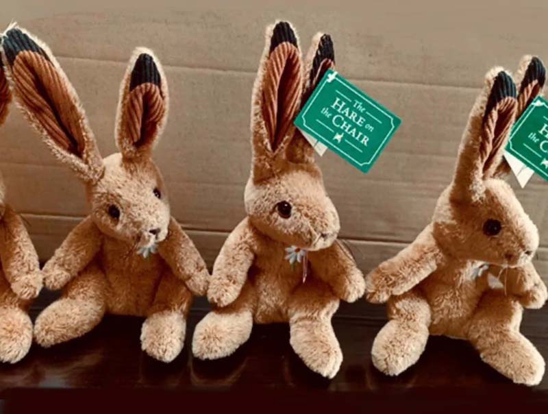 A group of rabbit plush toys featuring soft textures and branded hang tags for retail presentation.