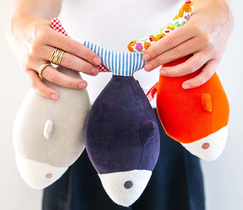 A set of colorful handmade fish-shaped plush toys with patterned fabric details, designed as playful decorative plush or children’s soft toys.