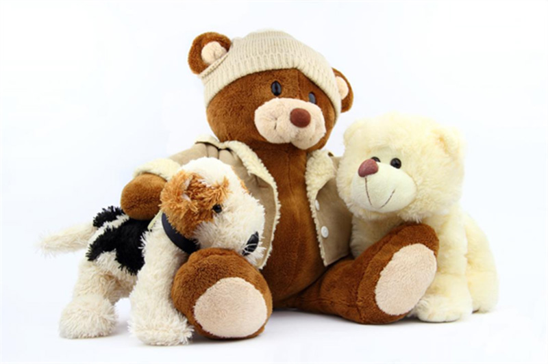 A group of teddy bear plush toys in different styles and outfits, showcasing soft textures and classic stuffed animal designs.