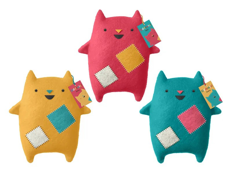 Three colorful monster plush toys with stitched patch details and simple facial expressions, showcasing playful character design and soft fabric textures.
