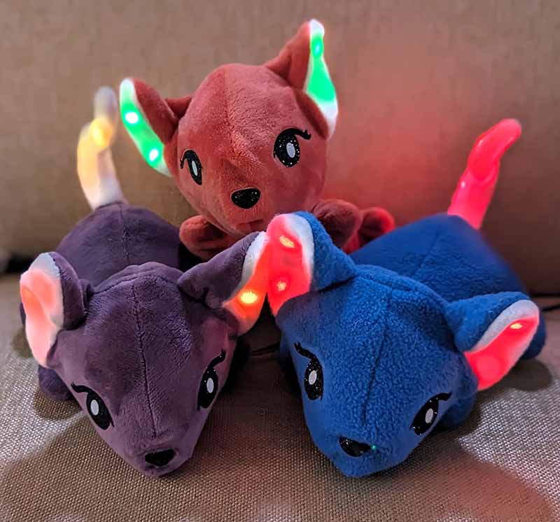 A set of three adorable plush mice in different colors, featuring glowing LED ears. The soft, plush toys combine cute designs with interactive lighting elements, adding a playful and modern twist to traditional stuffed animals.