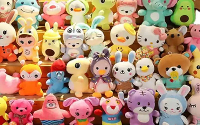 Large colorful collection of small plush toys arranged in rows, featuring cute animals, cartoon characters, and pastel designs commonly used for claw machines, gifts, and retail displays.