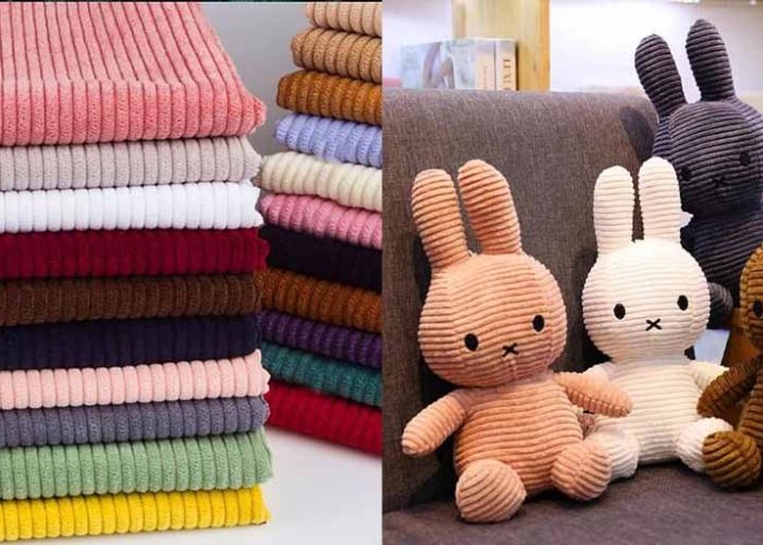 Corduroy fabric stacked in multiple colors alongside corduroy plush bunny toys, highlighting ribbed texture, softness, and color variety used in stuffed animal manufacturing.