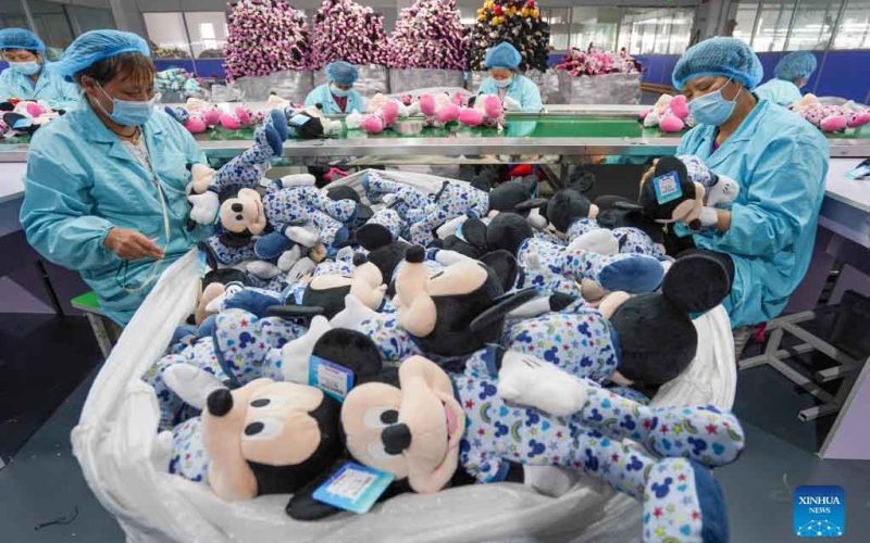 Workers sort and inspect plush toys in bulk to ensure uniform quality before final packing.