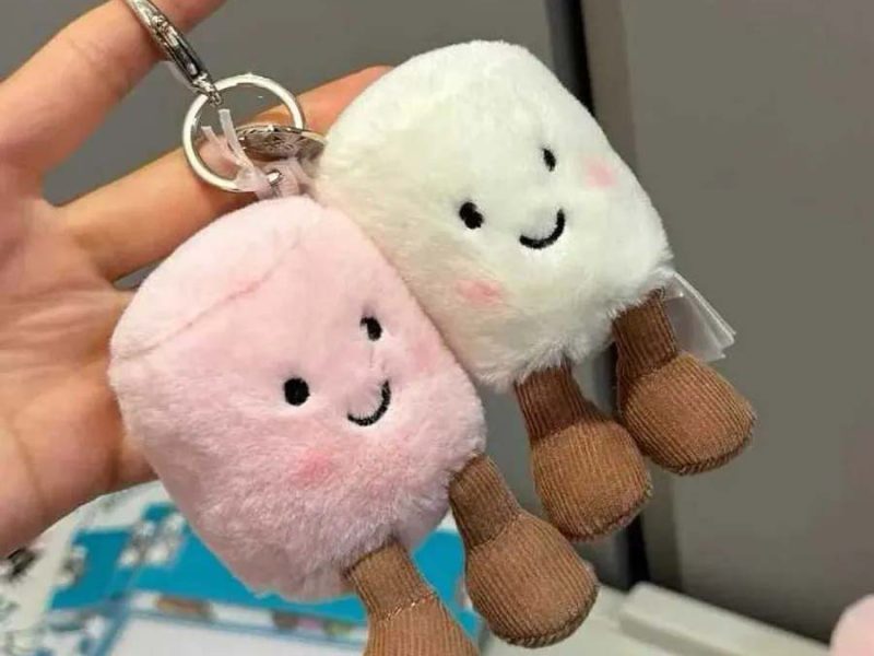 Cute pastel plush keychains with smiling faces and dangling legs.