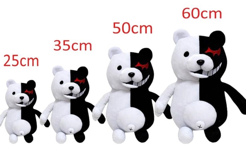 Four black-and-white plush bears displayed in increasing sizes—25 cm, 35 cm, 50 cm, and 60 cm—each with a split-color design and red eye detail.