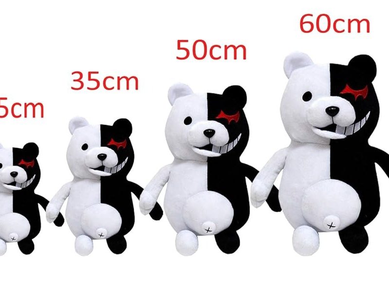 Four black-and-white plush bears displayed in increasing sizes—25 cm, 35 cm, 50 cm, and 60 cm—each with a split-color design and red eye detail.