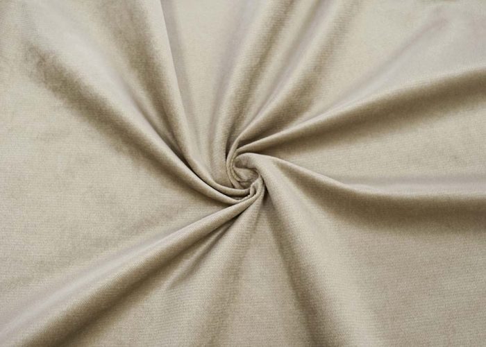 Close-up of beige velboa fabric showing its smooth, short-pile surface with gentle sheen, commonly used for plush toys and upholstery.