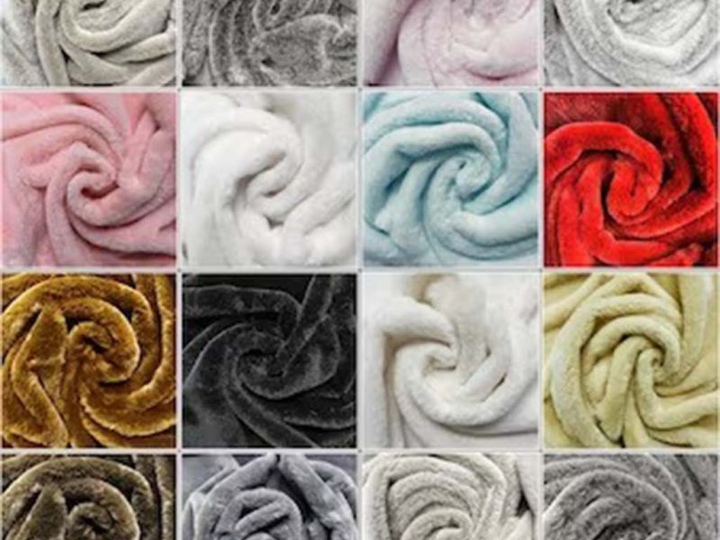 Collection of soft minky fabric samples in various colors including pink, red, white, gray, and gold arranged in swirl patterns.