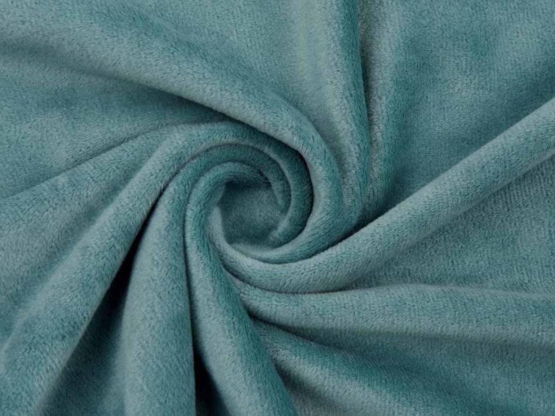 Close-up of teal smooth minky fabric twisted into a spiral, showing its soft texture and velvety surface ideal for plush toys.
