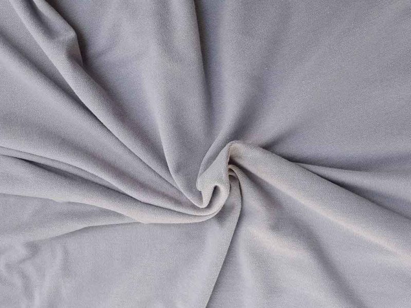 Smooth gray velboa fabric close-up showing its short, dense pile and subtle sheen, ideal for plush toys, upholstery, and soft decorative projects.