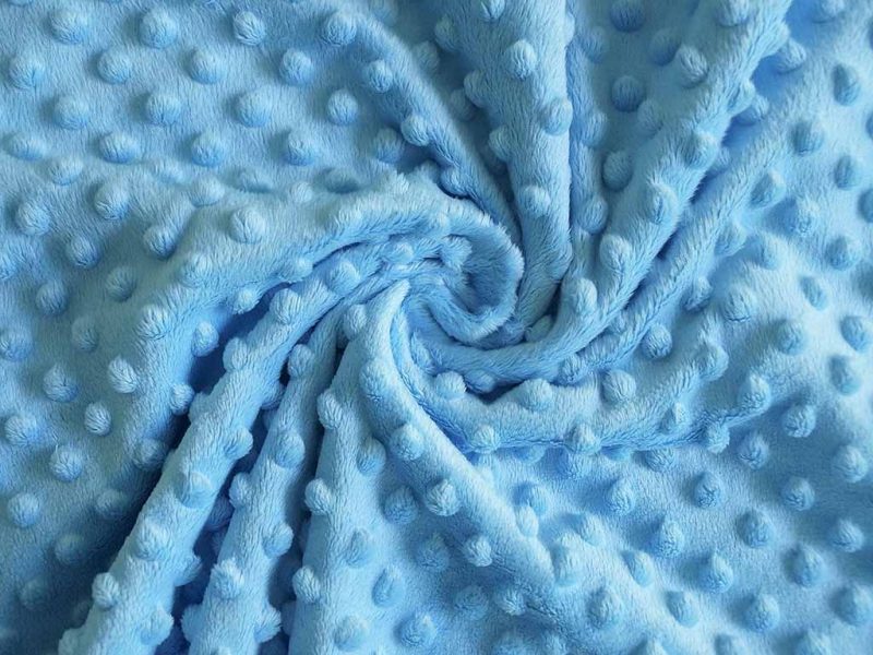 Soft blue minky plush fabric with raised dot texture, commonly used for baby toys and stuffed animals.
